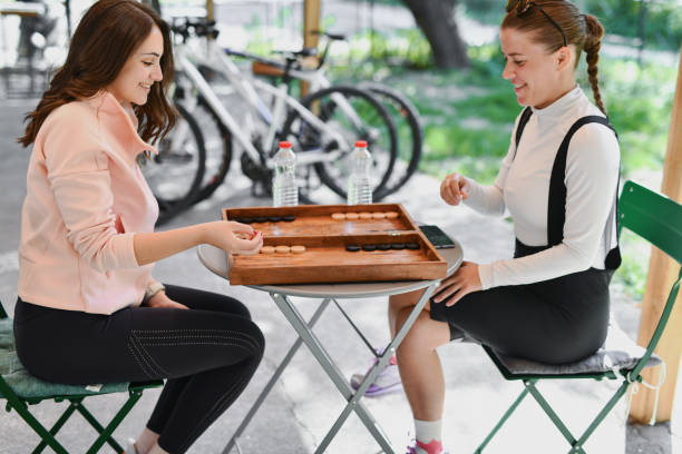 istock Female Adult Strategizing Next Move in Backgammon While Playing with Friend and Smiling 2177277933