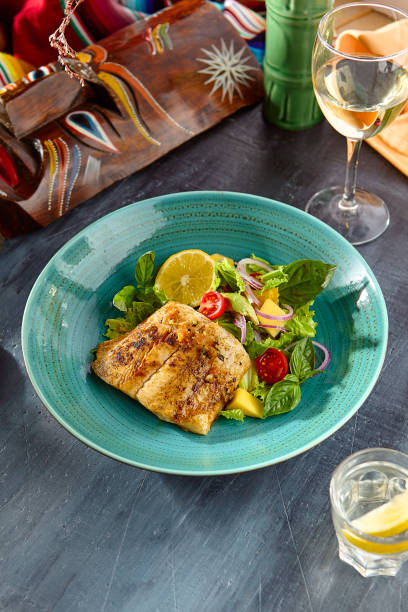 istock Grilled White Fish Steak with Fresh Veggie Salad in Vibrant Setting 2177279646