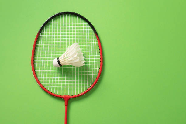 Male and female players in badminton mixed doubles match.