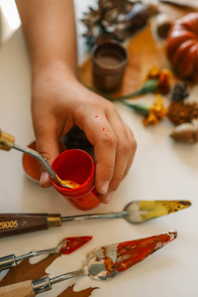 istock Creative autumn art activity with paint and natural materials like pine cones, acorns, and chestnuts, crafting seasonal decorations 2177280953
