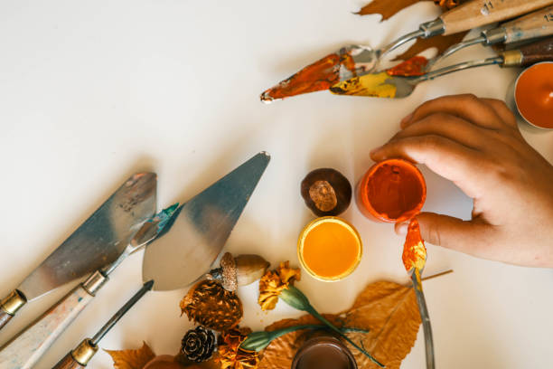 istock Creative autumn art activity with paint and natural materials like pine cones, acorns, and chestnuts, crafting seasonal decorations 2177280954