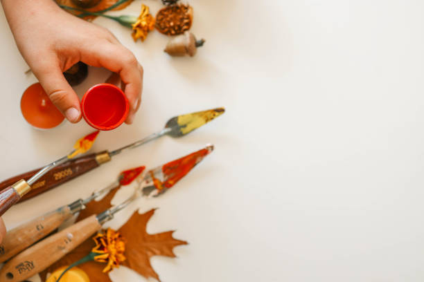 istock Creative autumn art activity with paint and natural materials like pine cones, acorns, and chestnuts, crafting seasonal decorations 2177280955