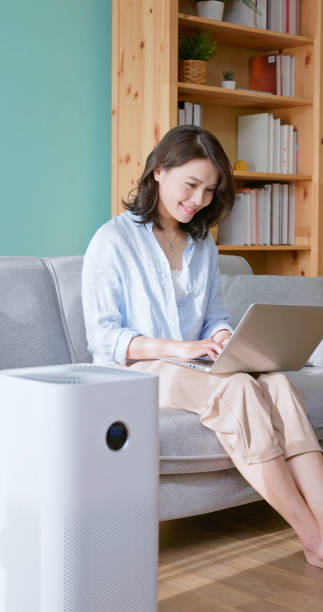 istock woman use air purifier home 2177285127