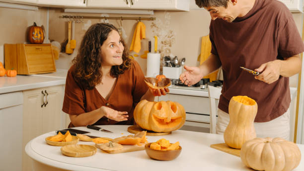 istock Middle-aged married couple carves a pumpkin for Halloween 2177286346