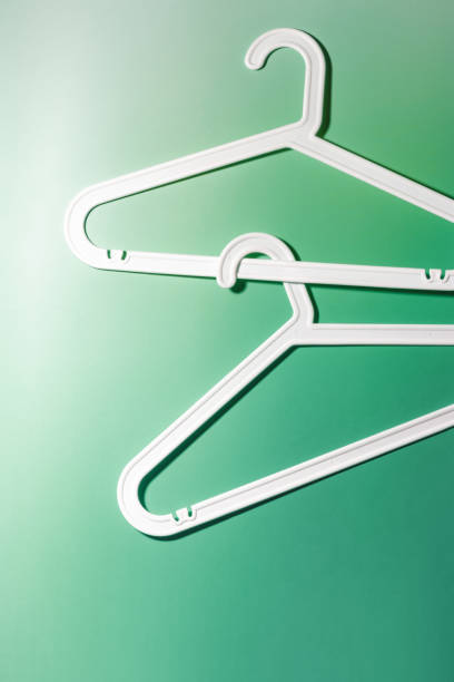 istock Top view White Plastic hangers, minimal style layout on white green gradient background, Clothes rack for organizing clothes in closets or retail stores, fashion, organization concept, copyspace 2177288837