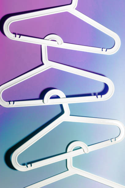 istock Top view minimal style pattern of white plastic hangers with hooks on purple blue background. Flat lay of Clothes racks for hanging garments. Minimal trend photo, lifestyle or interior design concept 2177288849