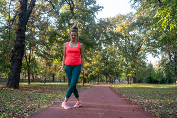 istock Woman doing jumping jacks at park 2177288903