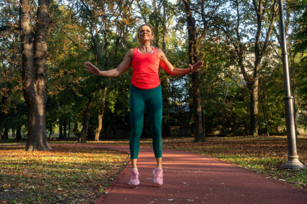 istock Woman doing jumping jacks at park 2177288927