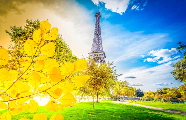 Paris Eiffel Tower with park in Paris, France. Eiffel Tower is one of the most iconic landmarks of Paris at fall