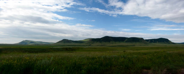 istock Beautiful panoramic view with green grass and hills in the background 2177290995