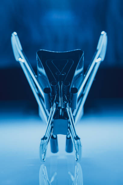 Closeup photo of black paper clips backlit over a reflective surface and blue lighting. Office concept. Elegant lighting.
