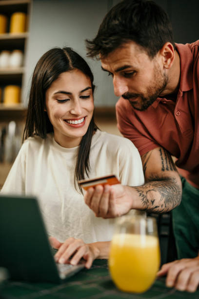 istock Loving couple using a credit card and laptop 2177293846