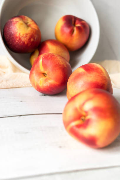 istock ripe nectarines. on a wooden table. fruits 2177297546