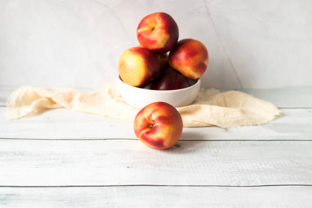 istock ripe nectarines. on a wooden table. fruits 2177297567