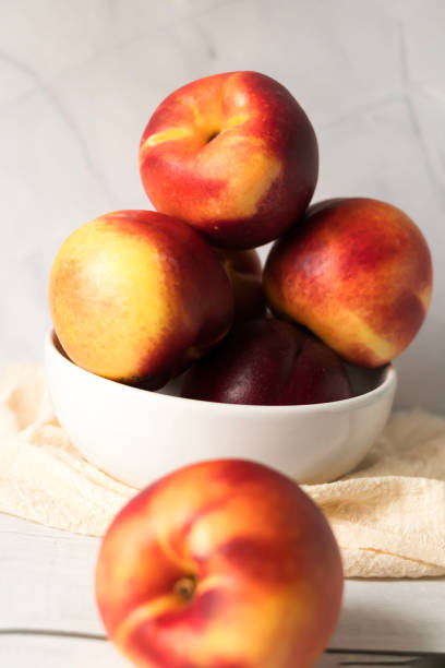 istock ripe nectarines. on a wooden table. fruits 2177297569