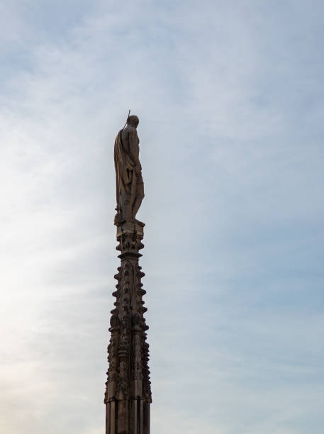 A picture of a Duomo di Milano or Milan Cathedral roof spire and statue.