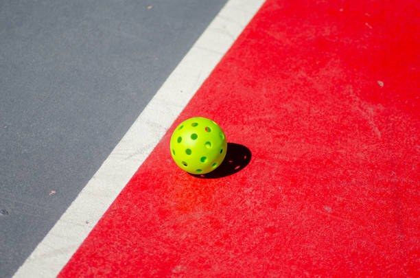 istock green pickleball ball on a court surface 2177300737