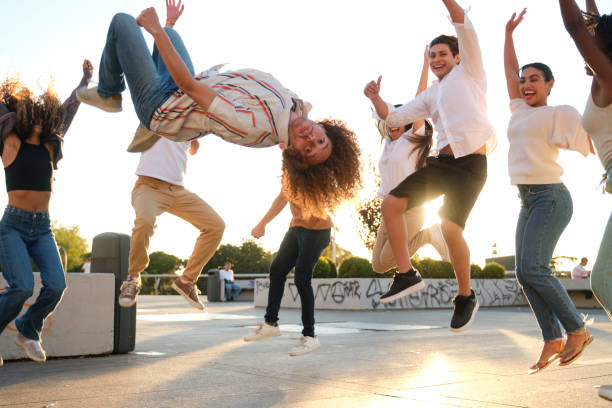 istock Group of friends jumping together outdoors having fun 2177300925