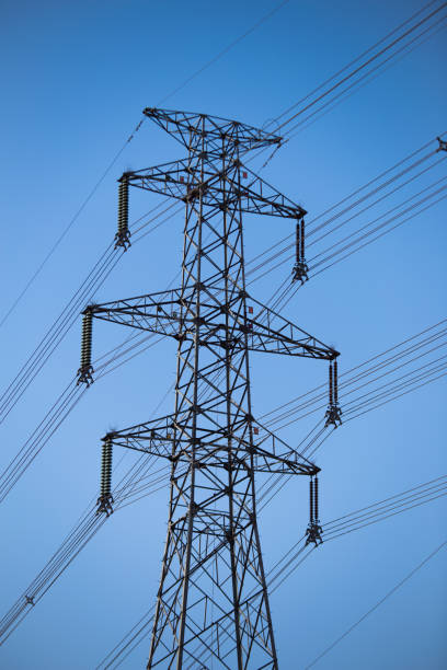 istock Abstract pattern from bottom view of high voltage pole power transmission tower with clear sky sunny day background in monochrome tone. Green energy, environmental conservation concept. 2177301582