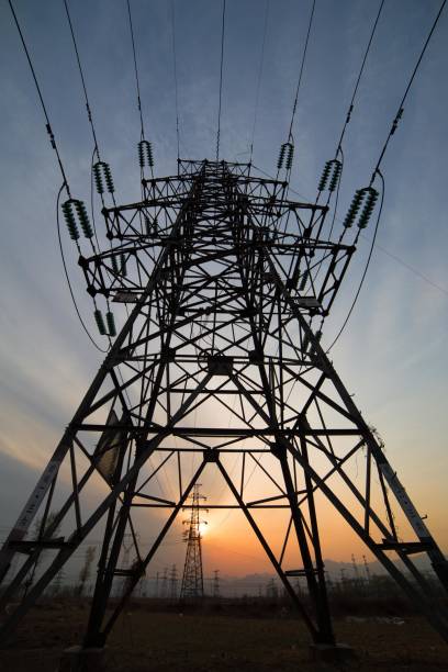 istock Huge electricity pylons carrying high voltage power lines at sunset 2177301809