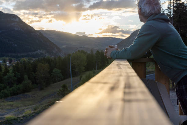 istock Mature man watches sunrise from cabin deck 2177305008