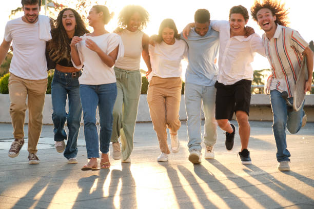 istock Group of happy young people running together at sunset 2177305055