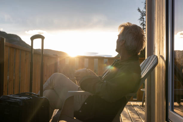 istock Mature man watches sunrise from cabin deck 2177305290