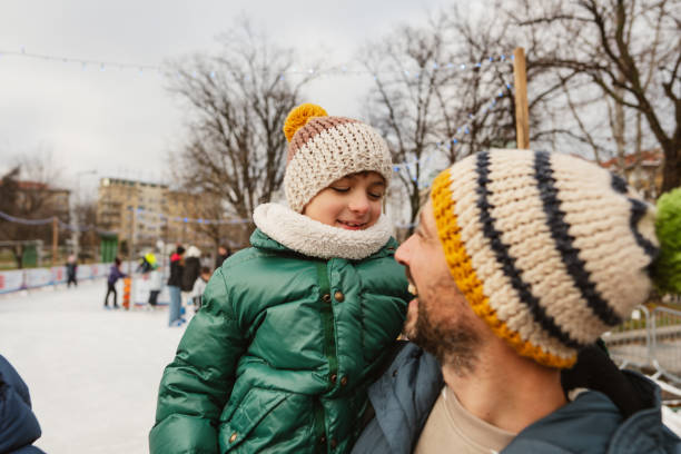 Photo of father and son smiling at each other