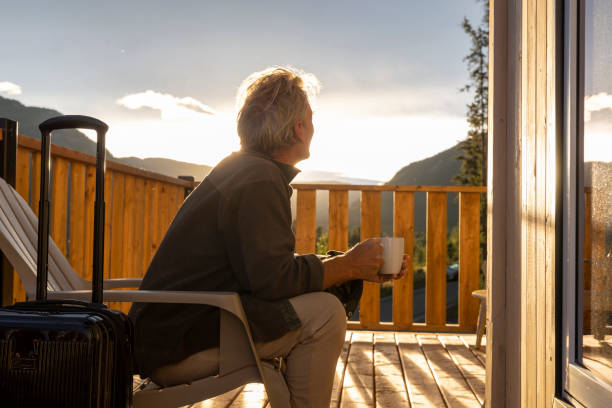istock Mature man watches sunrise from cabin deck 2177305411