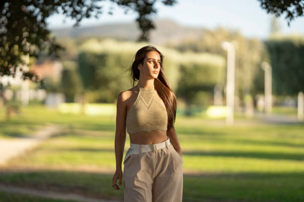 istock Young woman walking in public park 2177305821