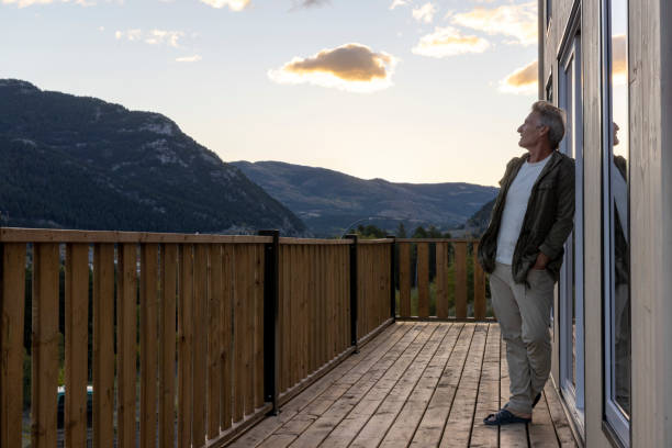 istock Mature man watches sunrise from cabin deck 2177305839