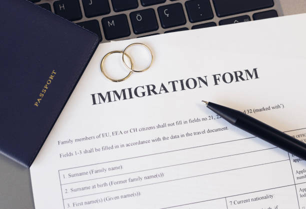 istock Immigration form and passport for marriage. Application to register permanent residence. 2177307723