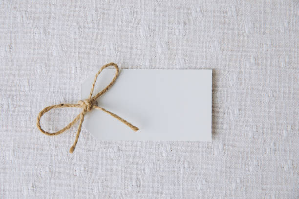 A plain, rectangular kraft paper gift tag with a gold string, ideal for labeling gifts or adding personalized messages to presents. The natural texture offers a rustic and minimalist touch to holiday or everyday packaging.