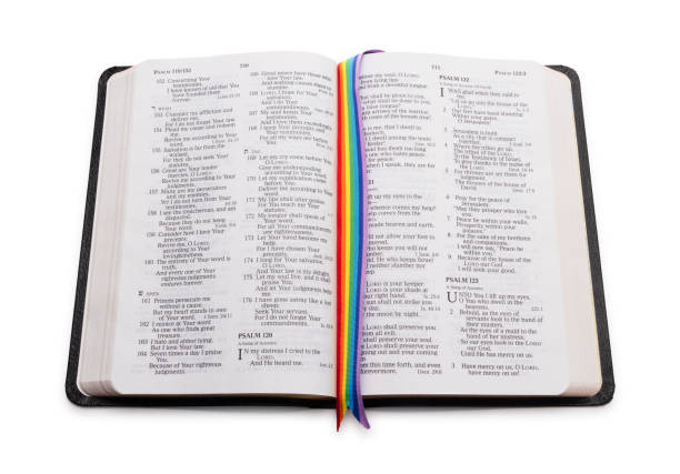Open Bible with LGBTQ Rainbow Ribbon Isolated on White