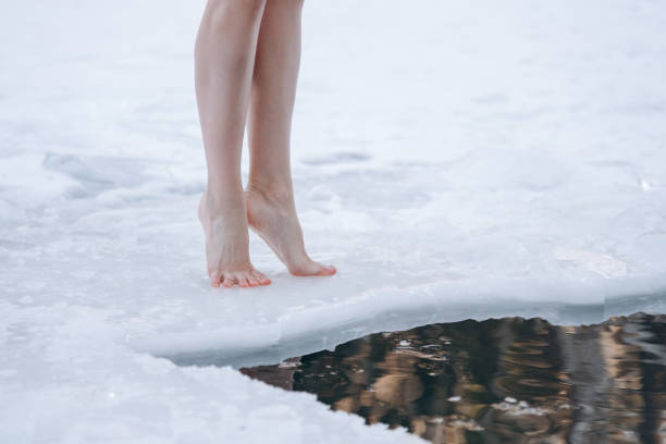 istock girl legs getting into ice cold water 2177309080