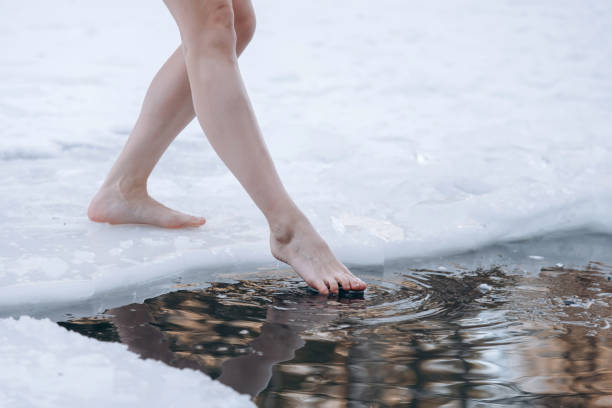 istock girl legs getting into ice cold water 2177309081