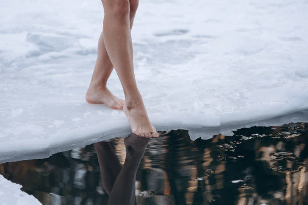 istock girl legs getting into ice cold water 2177309082