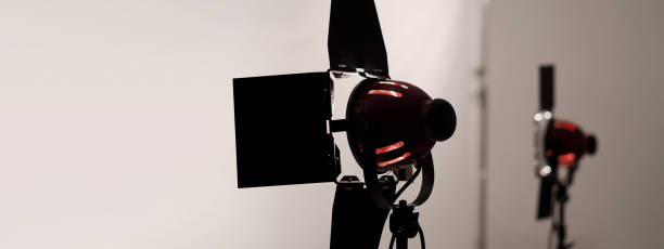 istock Photo or Video production studio with professional equipment preparation before shooting. Studio LED continuous lights arranging behind diffuser plates for softer light to the product and background. 2177309264