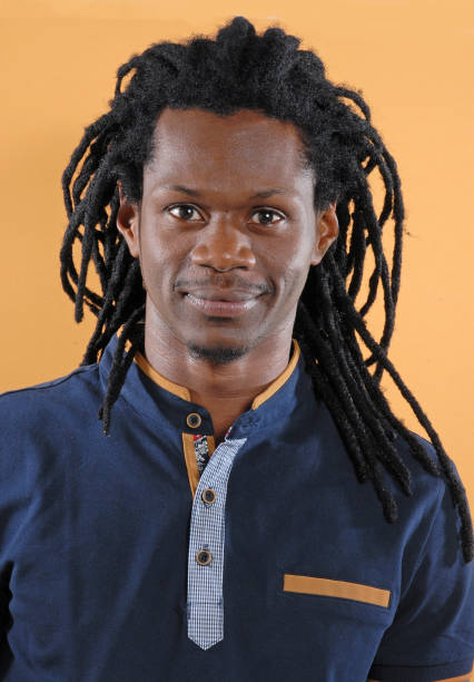 istock African Rastafarian man portrait on orange background. 2177311370