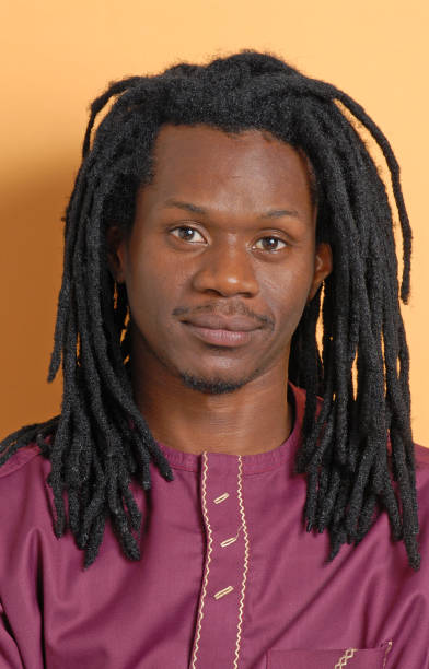 istock African Rastafarian man portrait on orange background. 2177311762