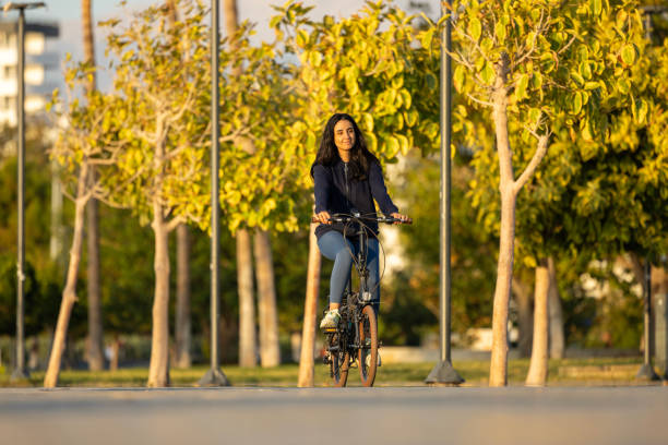 istock Beautiful woman riding a bicycle by the shore 2177311784