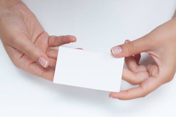 istock Female hand holding blank business cards 2177312287