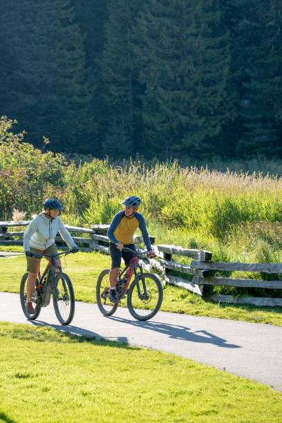 istock Mature couple bike on paved pathway 2177314112