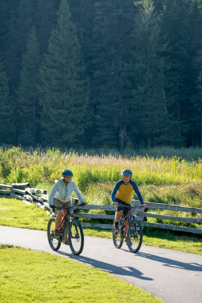 istock Mature couple bike on paved pathway 2177314114