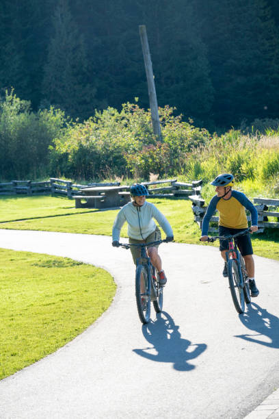 istock Mature couple bike on paved pathway 2177314228