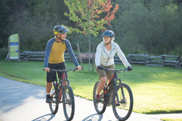 istock Mature couple bike on paved pathway 2177314316