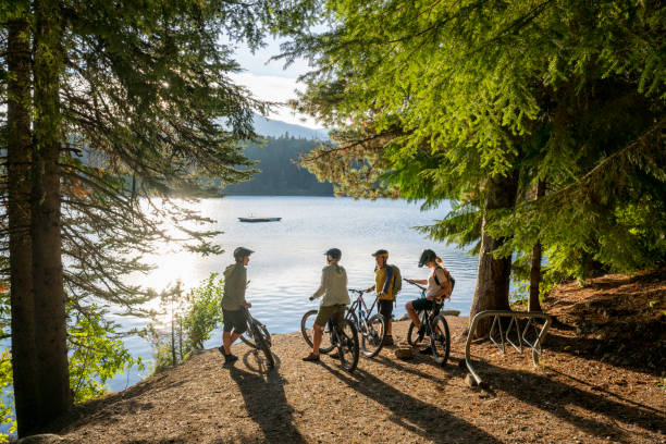 istock Family with bicycles pause on lakeshore 2177314470