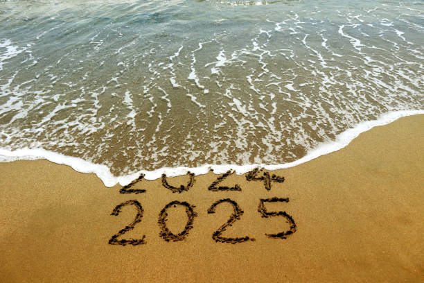 istock New year 2025 and 2024 on sandy beach with waves 2177315982