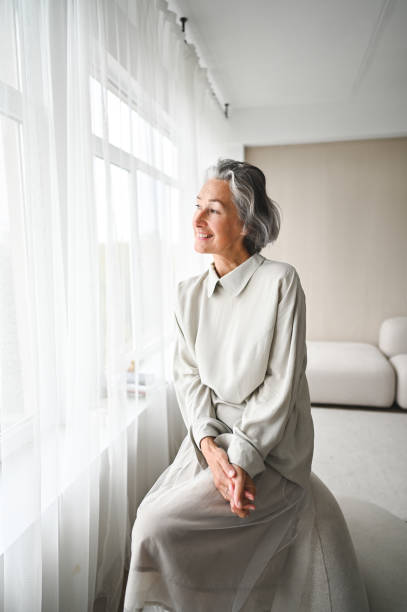 istock Senior woman looking throw window. 2177316008