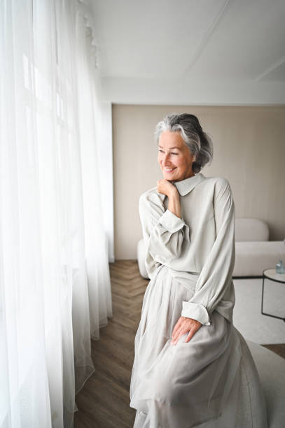 istock Cheerful mature woman looking throw window at home. 2177316061